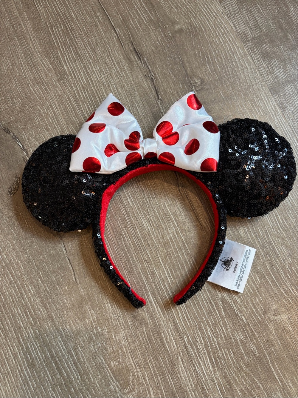 Disney Parks Minnie Mouse headband  black sequin ears and a red polka dot bow.